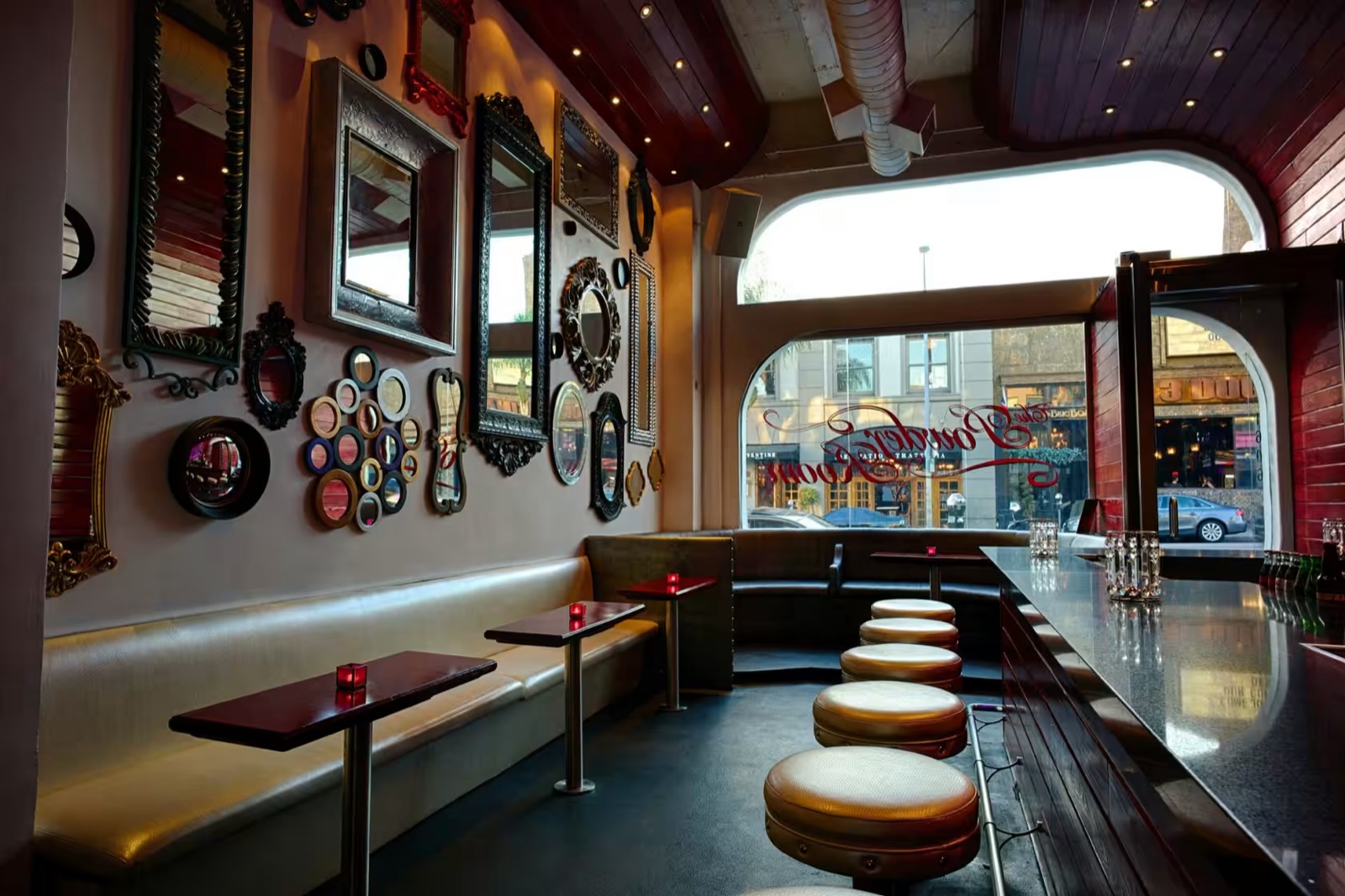 The Powder Room, with a mirrored gallery wall, leather banquettes and window seating over Cahuenga Boulevard.