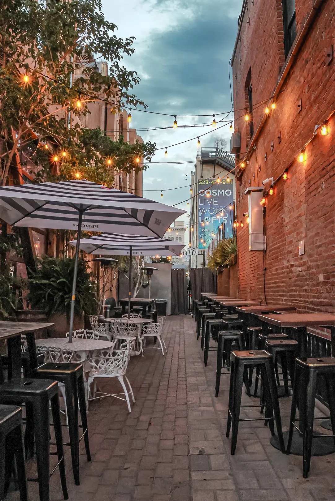 The EaCa Alley patio behind the building, with string lights and seating.