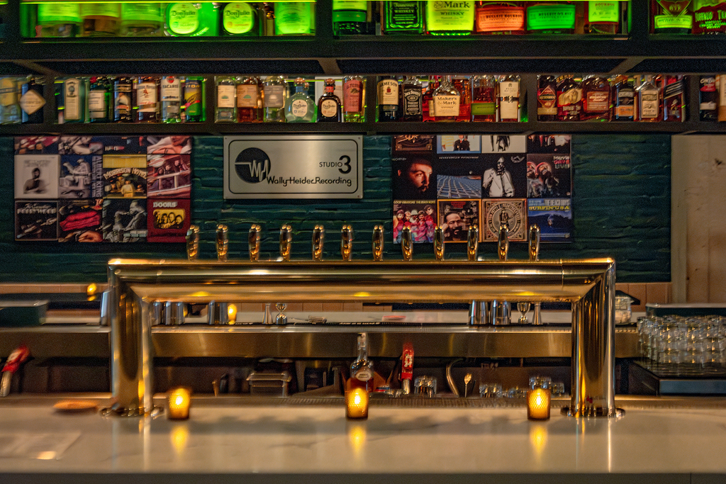 The bar at Tribute, with taps, back bar and music references