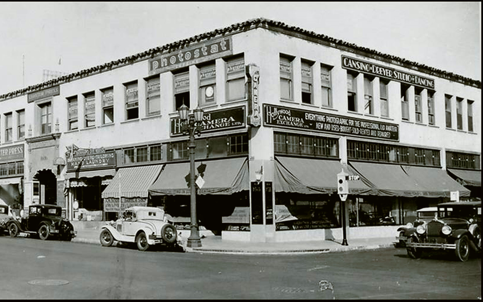 The corner in 1932, showing Cansino-Dreyer Studio of Dancing, Hollywood Camera Exchange and Cloister Press signage.